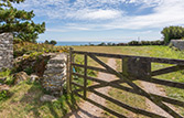 Opposite Kittiwake's front door is a five bar gate looking over farm fields to the sea